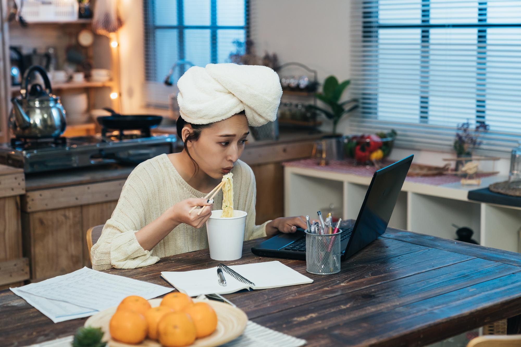 Studio counter with cooking tools and open laptop